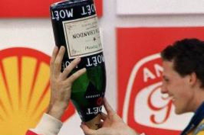 (FILES) - A file picture taken on March 28, 1993 shows Brazilian Formula One driver Ayrton Senna pouring Champagne over himself celebrating his victory in the Brazilian Grand Prix, Sao Paulo. The three-time Formula 1 world champion killed himself on May 1, 1994 during the San Marino Grand Prix in Imola, Italy. AFP PHOTO JULIO PEREIRA