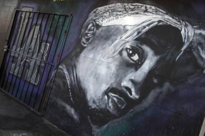 A wall dedicated to the memory of US rapper Tupac Shakur is seen on May 26, 2016 in Los Angeles, California. Twenty years after his death, Tupac still reigns. Other rappers have succeeded him in stardom, and promotional efforts around Tupac have been haphazard, but the artist who died at age 25 on September 13, 1996, in Las Vegas, maintains a hold that is among the most enduring in recent times. - TO GO WITH AFP STORY by Shaun TANDON, A wall dedicated to the memory of US rapper Tupac Shakur is seen on May 26, 2016 in Los Angeles, California. Twenty years after his death, Tupac still reigns. Other rappers have succeeded him in stardom, and promotional efforts around Tupac have been haphazard, but the artist who died at age 25 on September 13, 1996, in Las Vegas, maintains a hold that is among the most enduring in recent times. - TO GO WITH AFP STORY by Shaun TANDON,