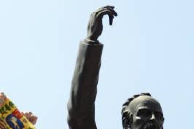 (FILES) This file photo taken on February 18, 2014 shows Venezuelan opposition leader Leopoldo Lopez standing at the monument of Cuba's most important independence-era hero, Jose Marti, as he demonstrates with a national flag in Caracas before turning himself in to authorities, on February 18, 2014. Lopez, held for three and a half years at a military prison for allegedly 