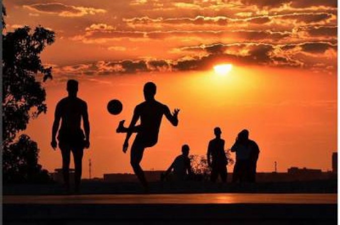 Pessoas jogam bola ao pôr do sol na Ermida Dom Bosco. -  (crédito: @anninha_brancio/instagram)