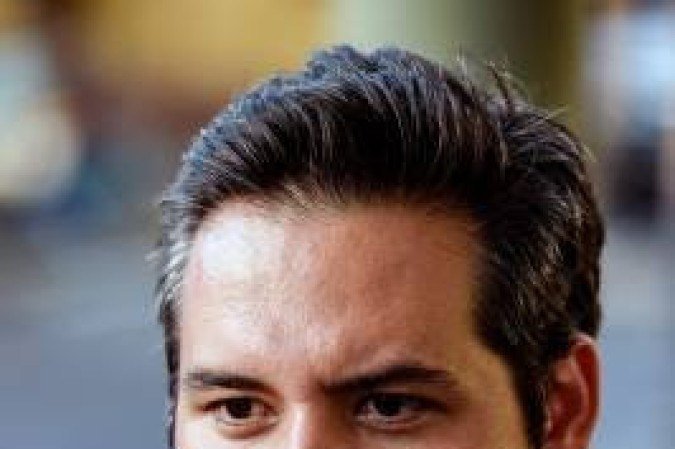 Venezuelan opposition candidate for the mayoralty of El Hatillo, Yon Goicoechea, speaks during an interview with AFP in Caracas on November 21, 2017. Venezuelans headed to the polls Sunday for mayoral elections that the opposition is boycotting amid an economic crisis, giving President Nicolas Maduro's party a clear path to victory. Yon Goicoechea is contesting the election against the wishes of his party because he says the opposition must 