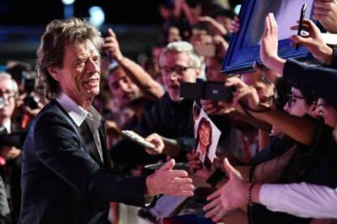 TOPSHOT - English singer, songwriter and actor Mick Jagger goes to see fans as he arrives for the screening of the film TOPSHOT - English singer, songwriter and actor Mick Jagger goes to see fans as he arrives for the screening of the film