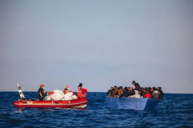 TOPSHOT - A handout picture released by German migrant rescue NGO Sea-Eye and taken on April 6, 2020, shows of the NGO on a rubber boat during an operation to rescue people from a small wooden boat in distress off the Libyan coast, before bringing them on board their vessel TOPSHOT - A handout picture released by German migrant rescue NGO Sea-Eye and taken on April 6, 2020, shows of the NGO on a rubber boat during an operation to rescue people from a small wooden boat in distress off the Libyan coast, before bringing them on board their vessel