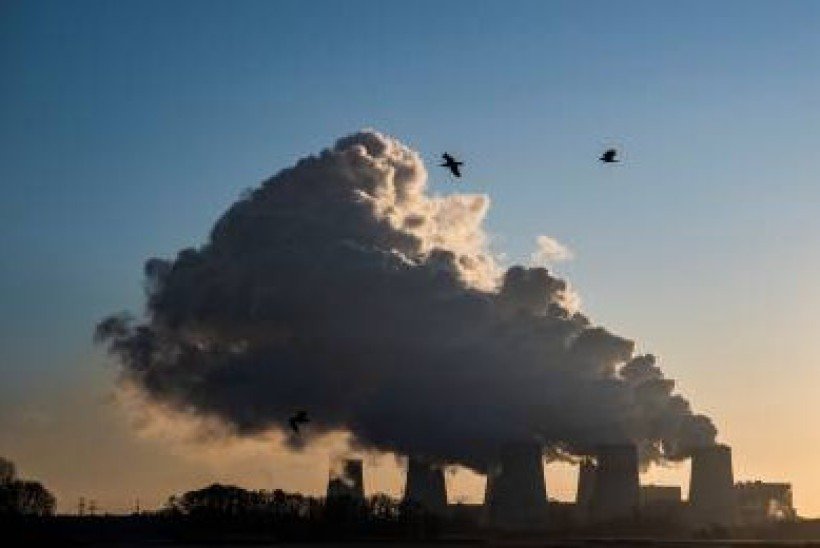 (FILES) In this file photo taken on November 30, 2019 A picture taken on November 30, 2019 shows smoke and vapor rising from the cooling towers and chimneys of the lignite-fired Jaenschwalde Power Station near Peitz, eastern Germany.  Several dozen climate activists occupied two opencast coal mines in Germany hoping to put pressure on the government to accelerate plans to phase out the polluting fossil fuel. Around 60 protesters joined a demonstration at the Garzweiler mine near Cologne, police said, while about a dozen activists took part in a second protest at the Jaenschwalde mine in Brandenburg. / AFP / John MACDOUGALL
