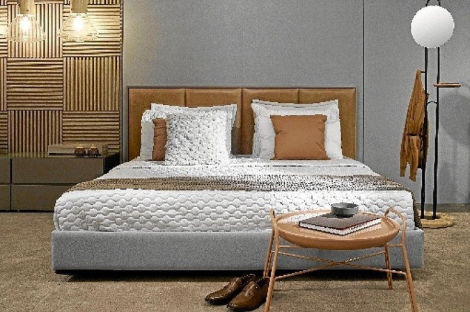 Outra tend&ecirc;ncia queridinha do momento s&atilde;o os estrados estofados. "Com eles, podemos usar uma colcha minimalista e apostar em almofadas e mantas para deixar a cama linda e despojada", afirma Tha&iacute;s Borges. Cama da Lider Interiores.