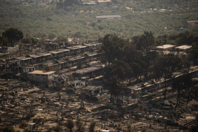Uma foto tirada em 16 de setembro de 2020 mostra os restos do acampamento de migrantes Moria queimado na ilha grega de Lesbos. - (crédito: ANGELOS TZORTZINIS / AFP) Uma foto tirada em 16 de setembro de 2020 mostra os restos do acampamento de migrantes Moria queimado na ilha grega de Lesbos. - (crédito: ANGELOS TZORTZINIS / AFP)