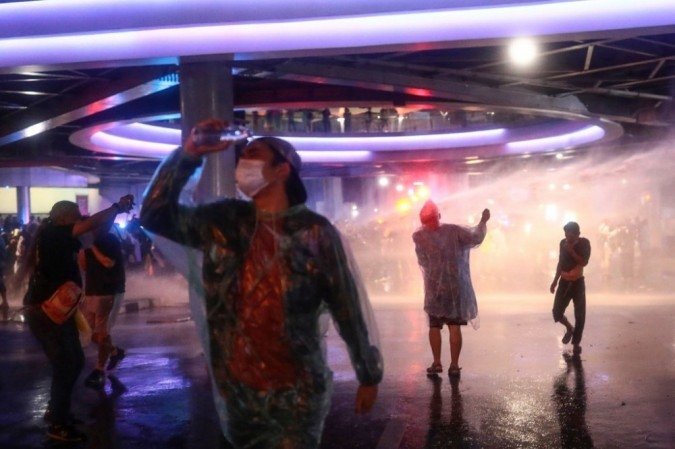 A polícia atira canhões de água contra manifestantes pró-democracia durante um comício antigovernamental em Bangkok em 16 de outubro de 2020. - (crédito: Jack TAYLOR / AFP) A polícia atira canhões de água contra manifestantes pró-democracia durante um comício antigovernamental em Bangkok em 16 de outubro de 2020. - (crédito: Jack TAYLOR / AFP)