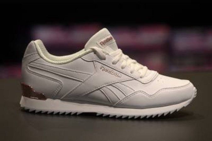 The logo of footwear and clothing company Reebok, a subsidiary of German sporting goods giant Adidas, is seen on a shoe of the brand in a store in Munich, southern Germany, on March 10, 2021. German sportswear group Adidas said on March 10, 2021 the pandemic sent its earnings plunging 78 percent in 2020 but it is expecting strong profit growth in the next four years. The Bavaria-based company, which is trying to sell its struggling US subsidiary Reebok, reported its net profits fell to 432 million euros (US 513 million) last year from 1.97 billion euros in 2019. / AFP / CHRISTOF STACHE