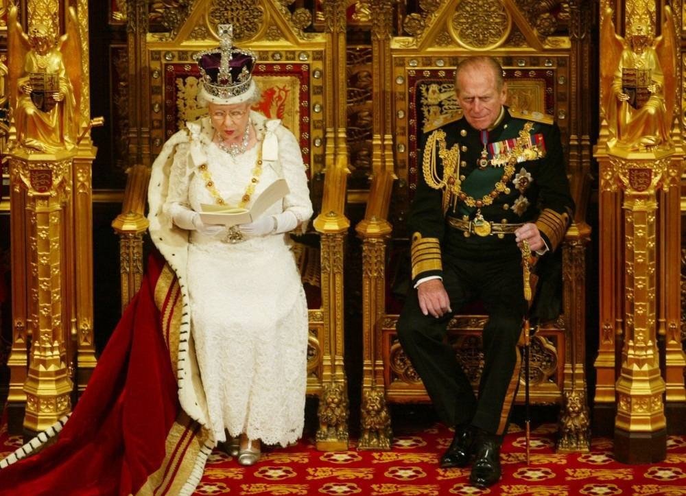  Britain's Queen Elizabeth (L) delivers her speech next to her husband Prince Philip, during the State Opening of Parliament at the Palace of Westminster in London, November 26, 2003. REUTERS/Russell Boyce