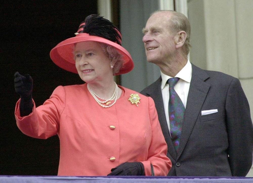 Britain's Queen Elizabeth II, accompanied by her husband Prince Philip,  waves from the balcony of Buckingham Palace, Tuesday June 4, 2002, at the climax of a weekend of celebrations marking her Golden Jubilee. (AP Photo/John Stillwell, Pool)