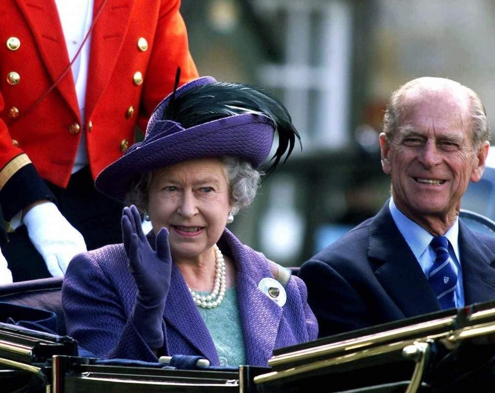 Britain's Queen Elizabeth II and her husband Prince Phillip leave Holyrood House in Edinburgh in a horsedrawn carriage Thursday July 1 1999 for the State Opening of  Scotland's new Parliament.   In a colorful ceremony melding populism with ancient tradition, Queen Elizabeth II  opened Scotland's first Parliament in nearly 300 years. (AP PHOTO/Andy Barr, POOL)