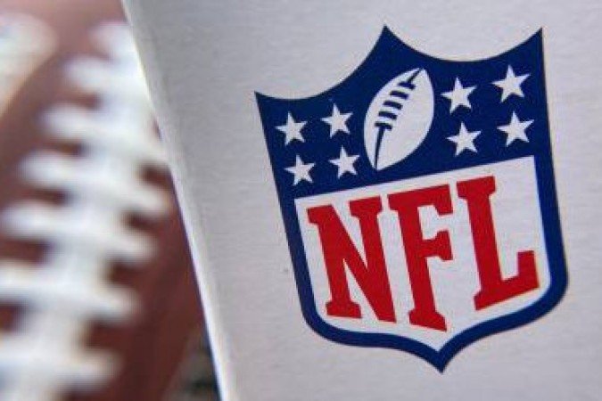 (FILES) In this file photo taken on August 24, 2020 the NFL logo is seen on a football packaging in Los Angeles. The National Football League is urging teams to make Covid-19 vaccines (FILES) In this file photo taken on August 24, 2020 the NFL logo is seen on a football packaging in Los Angeles. The National Football League is urging teams to make Covid-19 vaccines