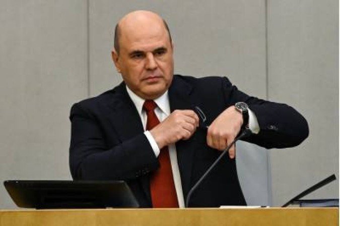 Russian Prime Minister Mikhail Mishustin gets ready to give a report on the government's work over the previous year at the State Duma, the lower chamber of Russia's parliament, in Moscow on May 12, 2021. / AFP / Kirill KUDRYAVTSEV