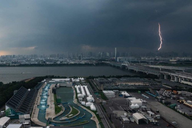 A bolt of lightning is seen in the background past the Kasai Canoe Slalom Centre, the main venue for canoe slalom during the Tokyo 2020 Olympic games, in Tokyo on July 11, 2021.
Philip FONG / AFP