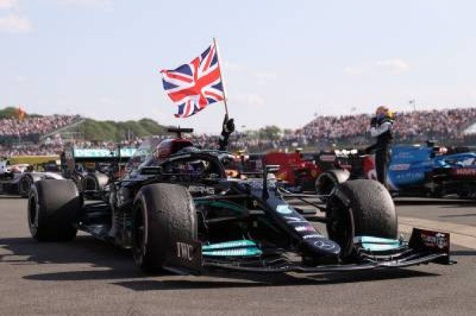 Mercedes' British driver Lewis Hamilton celebrates after winning the Formula One British Grand Prix motor race at Silverstone motor racing circuit in Silverstone, central England on July 18, 2021.  / AFP / POOL / LARS BARON