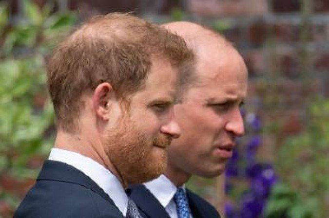 (FILES) In this file photo taken on July 01, 2021 Britain's Prince Harry, Duke of Sussex (L) and Britain's Prince William, Duke of Cambridge attend the unveiling of a statue of their mother, Princess Diana at The Sunken Garden in Kensington Palace, London which would have been her 60th birthday. Britain's Prince Harry is penning an intimate and honest memoir that will expose the 