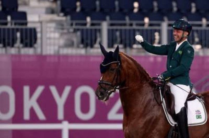 Brazil's Rodolpho Riskalla riding Don Henrico reacts after competing in the equestrian dressage individual test grade IV during the Tokyo 2020 Paralympic Games at Equestrian Park in Tokyo on August 26, 2021. (Photo by Behrouz MEHRI / AFP)