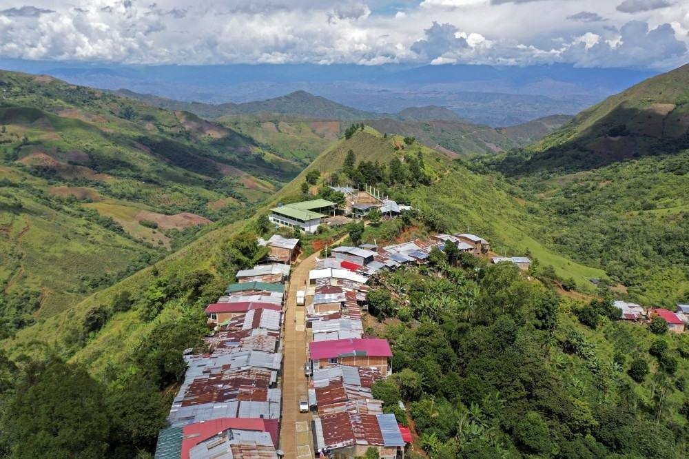 Aerial view showing a town built by coca growers with their own budget due to lack of support from the government, in the mountains of the Patia municipality, Cauca department, Colombia, on May 4, 2021. In the mountains and jungles of southwestern Colombia, peasants, migrants and women carrying babies toil determinedly in fields of coca despite the dangers and persecution they suffer, whilst Colombian President Ivan Duque issued a decree to reactivate the use of aerial glyphosate spraying in illicit coca crops.