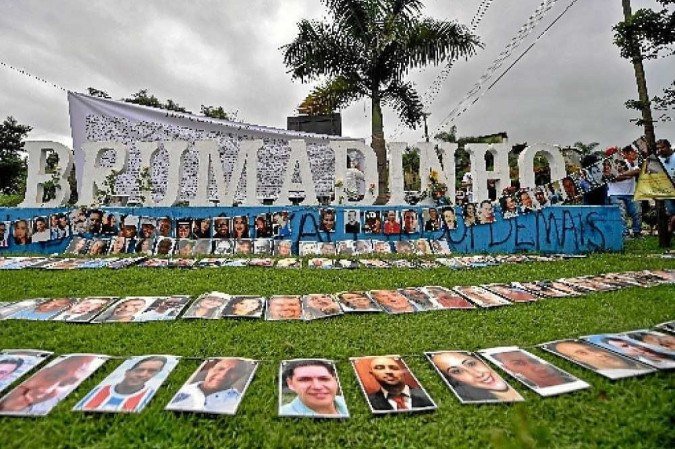 View of the portraits of the victims of the January 25, 2019 dam collapse next to the city sign, during a tribute in Brumadinho, state of Minas Gerais, Brazil, on January 25, 2020, to mark one year since the disaster which killed 270 people.  Brazil marks the first anniversary of the Brumadinho dam collapse, one of the country's worst industrial accidents. Millions of tons of toxic mining waste engulfed houses, farms and waterways, devastating the mineral-rich region in the southeastern state of Minas Gerais. It was the second such disaster involving Brazilian mining giant Vale, one of the biggest mining companies in the world, in three years. / AFP / DOUGLAS MAGNO..