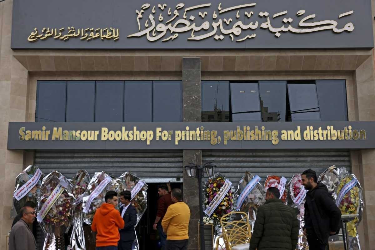 Workers prepare for the opening of the new Samir Mansour bookshop that was destroyed during last year's 11-day war between Israel and the Palestinian Hamas movement, in Gaza city on February 17, 2022. - Mansour?s beloved bookshop has been rebuilt and restocked following an international fundraiser. (Photo by MOHAMMED ABED / AFP)       