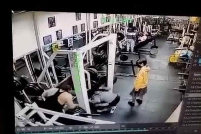 Ao tentar sustentar o peso da barra de ferro, mulher tem o corpo violentamente dobrado, instantaneamente. Ao ser 