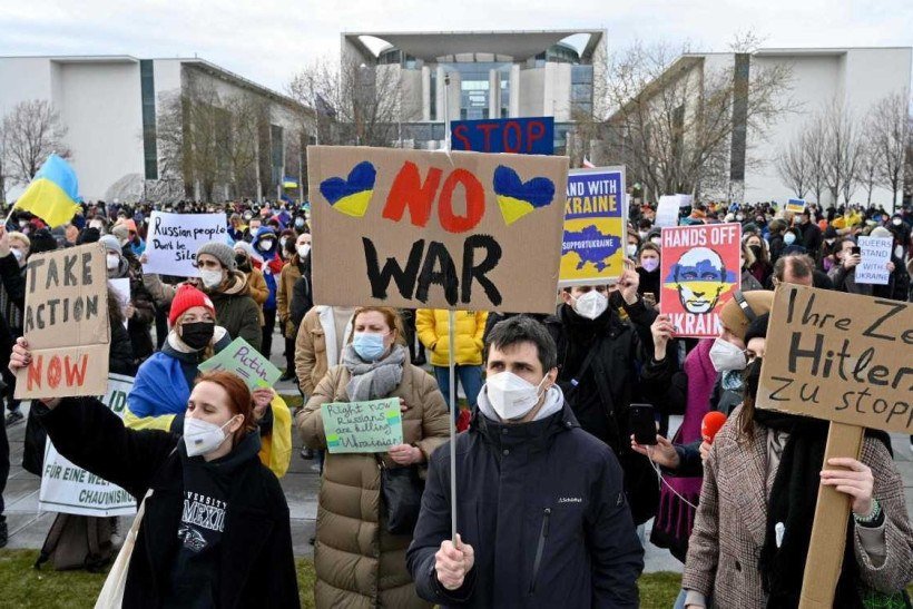  People protest against Russia's invasion of Ukraine on February 24, 2022 in front of the Chancellery in Berlin. (Photo by John MACDOUGALL / AFP)

      