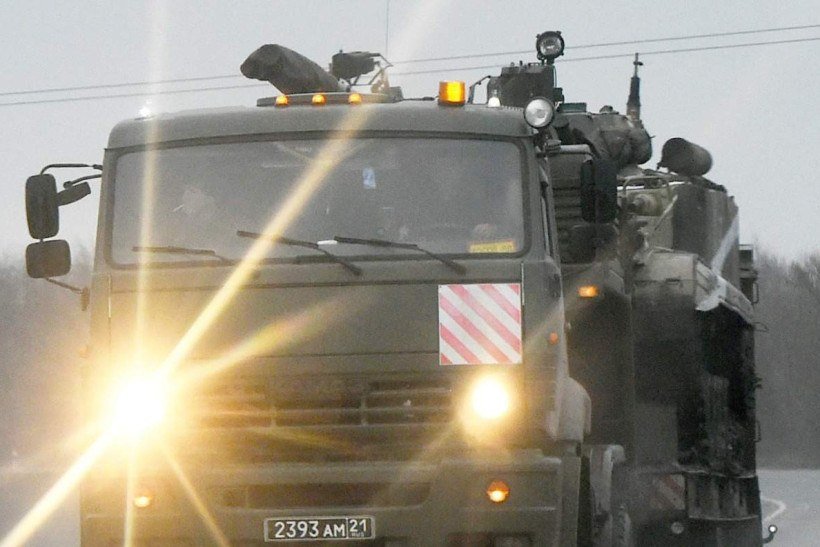  Russian military vehicles move on a road in the southern Russian Rostov region on February 24, 2022. Russian President Vladimir Putin launched a full-scale invasion of Ukraine on Thursday, killing dozens and triggering warnings from Western leaders of unprecedented sanctions. Russian air strikes hit military installations across the country and ground forces moved in from the north, south and east, forcing many Ukrainians flee their homes to the sounds of bombing. (Photo by STRINGER / AFP)
      