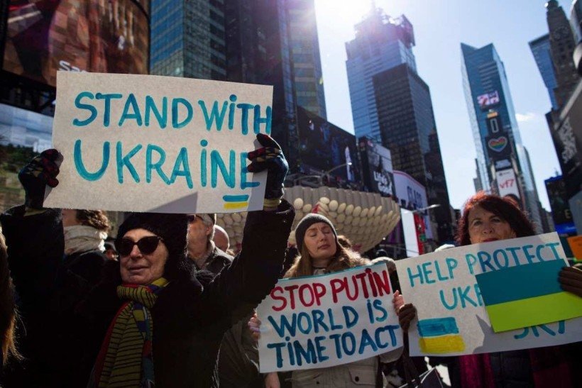  Demonstrators gather in support of Ukraine during a rally in Times Square, New York, on February 26, 2022. Russia's invasion force is being slowed and frustrated by unexpectedly stiff resistance from Ukrainian troops, keeping them well outside Kyiv, a senior US defense official said. (Photo by Kena Betancur / AFP)

      