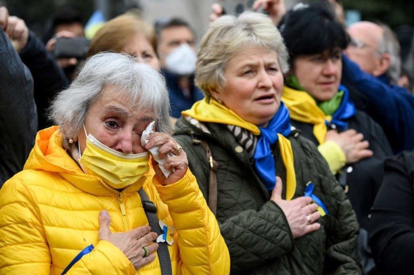  Protestors cry and hold hands on their chests as they chant during a demonstration in support of Ukraine and to protest against Russia's invasion of the country, on the Plaza Catalunya square in Barcelona, on March 6, 2022. - The number of people fleeing Russia's invasion of Ukraine has topped 1.5 million, making it Europe's fastest growing refugee crisis since World War II, the United Nations said on March 6. UN officials said they expected the wave of refugees to intensify further as the Russian army pressed its offensive, particularly toward the Ukranian capital Kyiv.