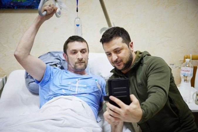 Volodymyr Zelensky visita um hospital de Kiev, a capital sitiada por tropas russas, e tira selfie com combatente internado - (crédito: AFP) Volodymyr Zelensky visita um hospital de Kiev, a capital sitiada por tropas russas, e tira selfie com combatente internado - (crédito: AFP)