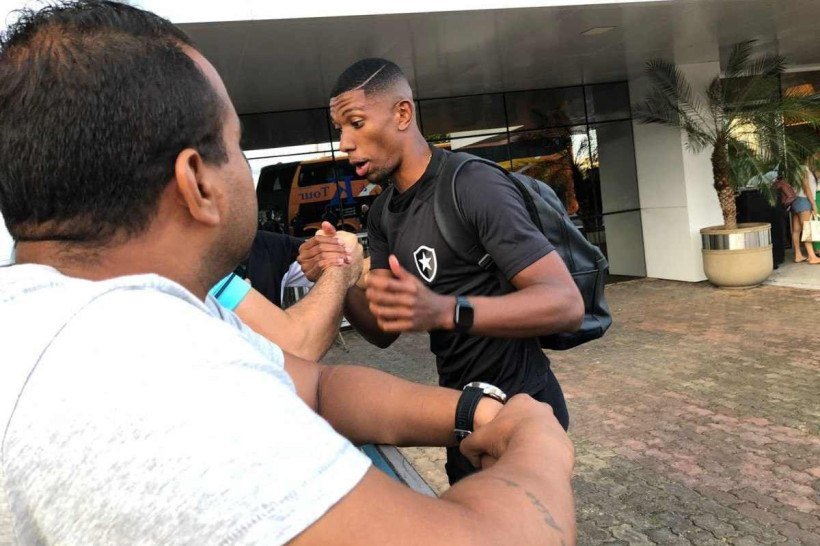 Zagueiro Kanu atende os fãs botafoguenses na chegada ao DF