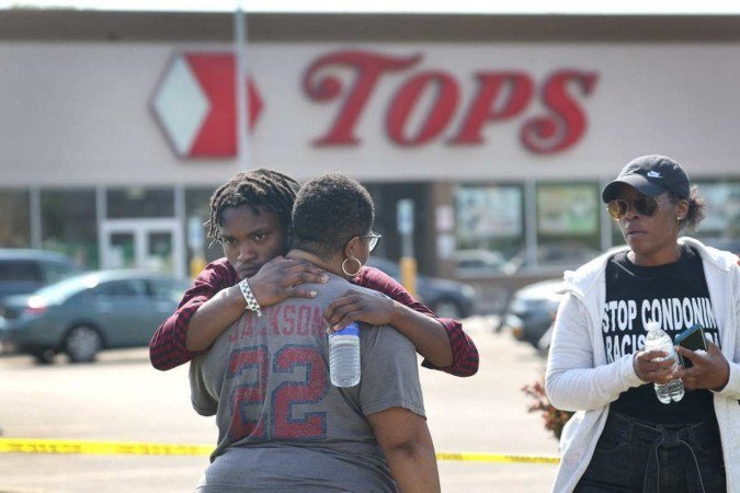Moradores de Buffalo se abraçam diante do Tops Friendly Markets, no dia seguinte ao tiroteio em massa: cidade em choque após crime de ódio - (crédito: Scott Olson/Getty Images/AFP) Moradores de Buffalo se abraçam diante do Tops Friendly Markets, no dia seguinte ao tiroteio em massa: cidade em choque após crime de ódio - (crédito: Scott Olson/Getty Images/AFP)