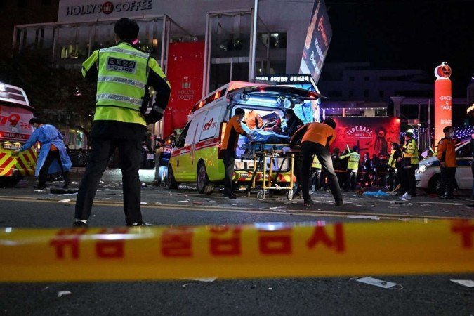 Paramedics put one of the injured in an ambulance on the main street of Itaewon 