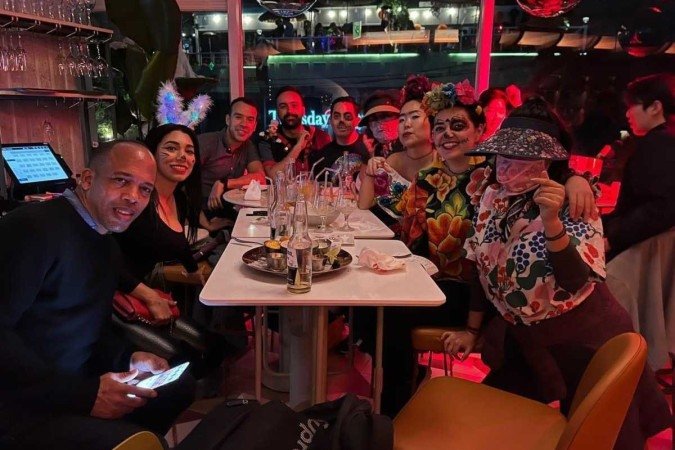Thiago Mattos (background, center) and friends celebrate Halloween, just before the riot 