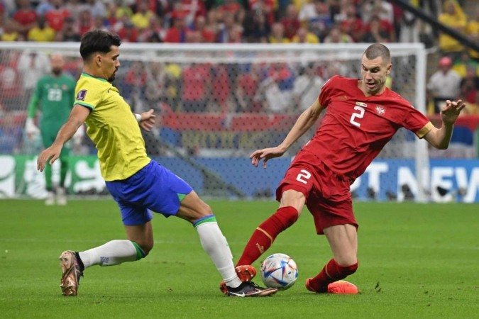  Brazil's midfielder #07 Lucas Paqueta (L) fights for the ball with Serbia's defender #02 Strahinja Pavlovic (R) during the Qatar 2022 World Cup Group G football match between Brazil and Serbia at the Lusail Stadium in Lusail, north of Doha on November 24, 2022. (Photo by NELSON ALMEIDA / AFP)
      