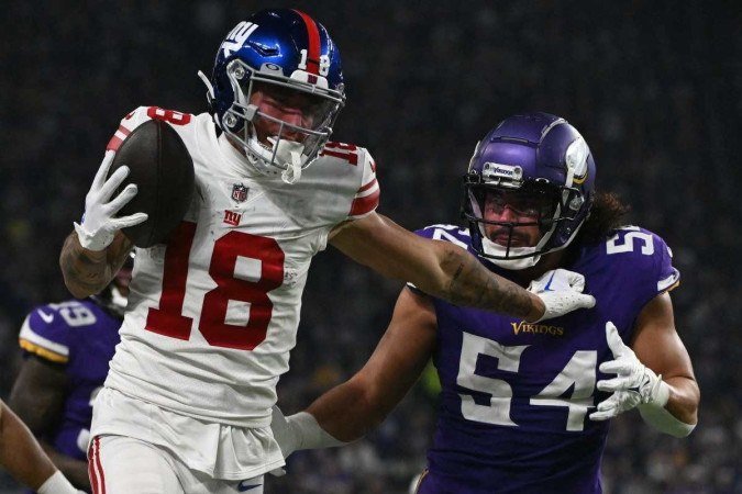 Defesa dos Vikings não se mostrou páreo para um ataque com repertório e composto de vários nomes como Isaiah Hodgins (com a bola) -  (crédito:  Getty Images via AFP)
