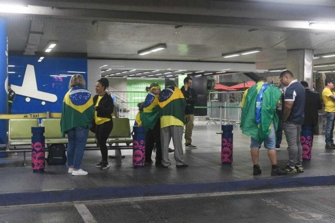 Apoiadores de Bolsonaro aguardam o desembarque do ex-presidente no saguão do Aeroporto de Brasília