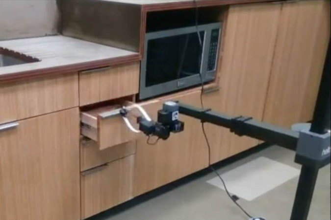 Braço robótico abre gaveta, reproduzindo ação humana observada previamente: movimento estratégico para outras atividades cotidianas, segundo especialistas - (crédito: Universidade Carnegie Mellon/Divulgação) Braço robótico abre gaveta, reproduzindo ação humana observada previamente: movimento estratégico para outras atividades cotidianas, segundo especialistas - (crédito: Universidade Carnegie Mellon/Divulgação)