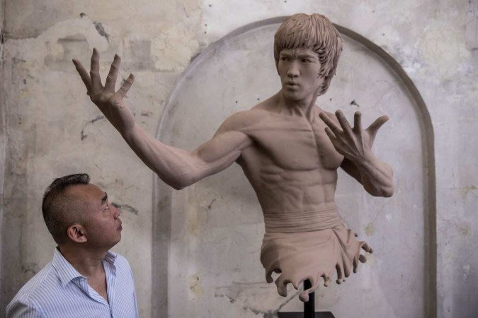 This photo taken on July 14, 2023 shows W. Wong, chairman of the Bruce Lee Club, posing for a photo at an art exhibition in Hong Kong, to mark the 50th anniversary of his death. The martial arts legend Bruce Lee, whose films spawned a kung fu craze around the world, was one of the first Asian men to achieve Hollywood superstardom, and his influence can still be felt in Hong Kong as fans held exhibitions and martial arts workshops this week to mark the 50th anniversary of his death.