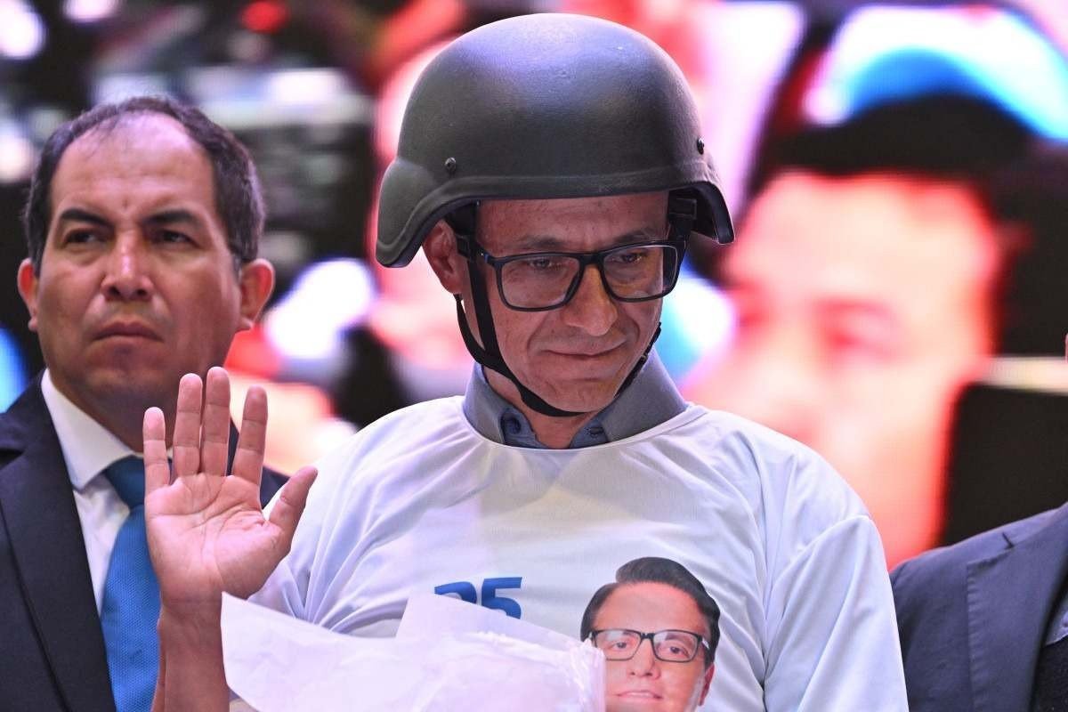 Amigo de Villavicencio, o jornalista e candidato do Partido Construye Christian Zurita se protege com capacete, em Quito 