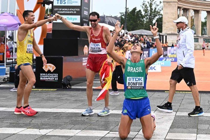 Third place winner Brazil's Caio Bonfim reacts while behind second place winner Sweden's Perseus Karlstrom congratulates race winner Spain's Alvaro Martin after the men's 20km race walk final during the World Athletics Championships in Budapest on August 19, 2023.
      