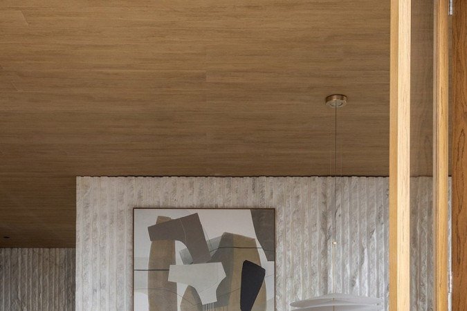 A inspiração do projeto de Larissa Dias é o casqueiro, parte externa dos blocos de mármore. No ambiente, a pedra reveste parede e compõe bancadas