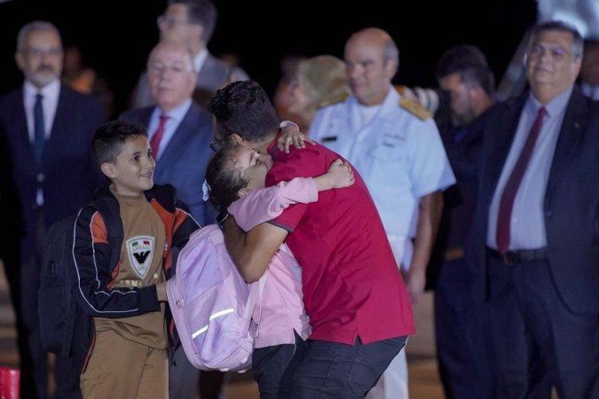Mohammed Jabr Ismil Abushanab, abraça seus filhos, após a chegada do avião presidencial com 32 resgatados da Faixa de Gaza que saiu do Cairo (Egito) para o Brasil. - (crédito: Rafa Neddermeyer/Agência Brasil) Mohammed Jabr Ismil Abushanab, abraça seus filhos, após a chegada do avião presidencial com 32 resgatados da Faixa de Gaza que saiu do Cairo (Egito) para o Brasil. - (crédito: Rafa Neddermeyer/Agência Brasil)