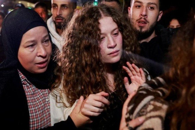 Ahed Tamimi, 22, foi fotografada se reencontrando com a mãe na Cisjordânia após sua soltura na quarta-feira (29) - (crédito: Reuters) Ahed Tamimi, 22, foi fotografada se reencontrando com a mãe na Cisjordânia após sua soltura na quarta-feira (29) - (crédito: Reuters)