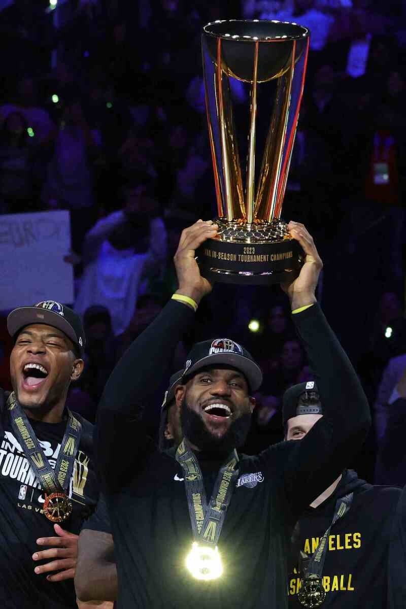 LeBron James #23 of the Los Angeles Lakers hoists the trophy with his teammates after winning the championship game of the inaugural NBA In-Season Tournament at T-Mobile Arena on December 09, 2023 in Las Vegas, Nevada. 