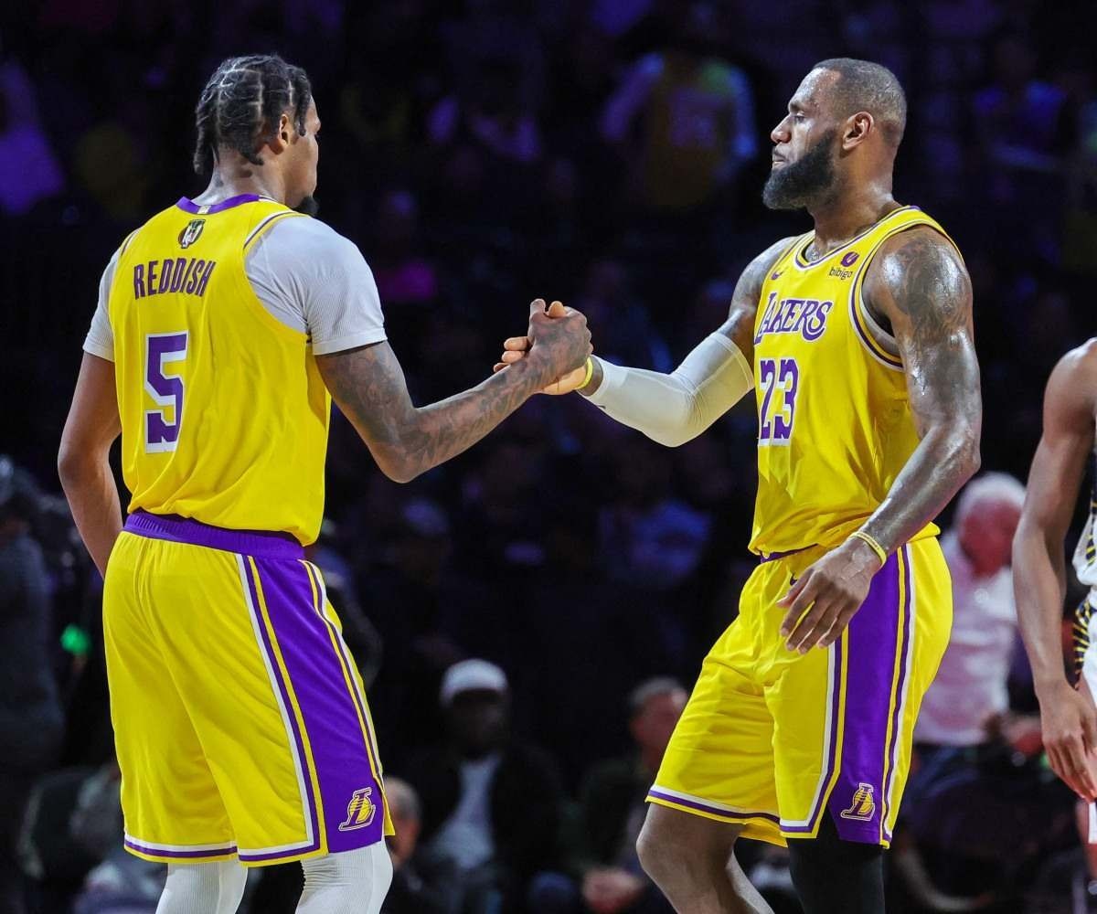 Cam Reddish #5 and LeBron James #23 of the Los Angeles Lakers shake hands as James checks out late in the fourth quarter of the championship game of the inaugural NBA In-Season Tournament at T-Mobile Arena on December 09, 2023 in Las Vegas, Nevada. The Lakers defeated the Pacers 123-109.