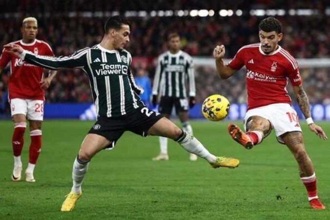 Bruno Fernandes (à direita) estica a perna numa disputa com o meia Ryan Yates (camisa 22) do Nottingham Forest - (crédito: AFP via Getty Images) Bruno Fernandes (à direita) estica a perna numa disputa com o meia Ryan Yates (camisa 22) do Nottingham Forest - (crédito: AFP via Getty Images)