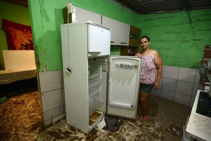 Sirleia dos Santos mostra a geladeira destruída: "E vou para onde, sem roupas, sem produtos de higiene e sem esperança? Eu me sinto sem saída" -  (crédito:  Marcelo Ferreira/CB/D.A Press)