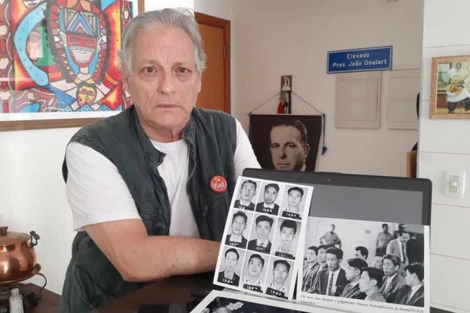 João Vicente, filho de Jango, com foto dos nove chineses torturados