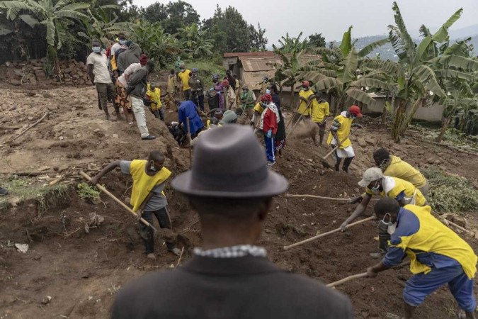 Aldeões e voluntários escavam em busca de restos mortais de vítimas do genocídio de Ruanda em 1994, escondidos sob as fundações de uma casa em Ngoma, Ruanda       -  (crédito: GUILLEM SARTORIO / AFP)